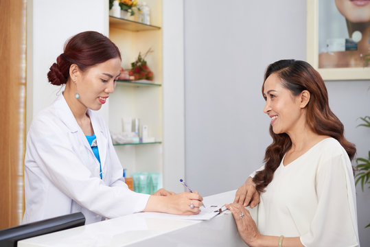 Asian Happy Woman Prepares Beauty Treatments At The Reception At Clinic