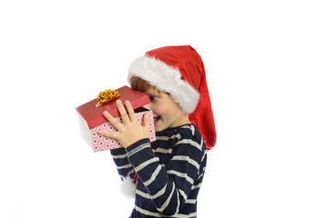Little boy in Santas hat looking inside the box. Christmas concept