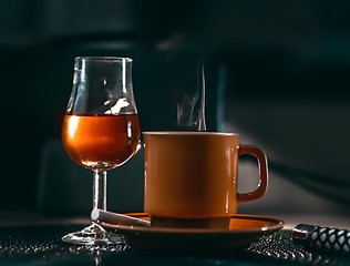 coffee cigarettes and brandy on the table. 