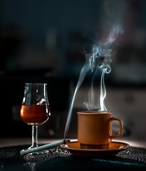 coffee cigarettes and brandy on the table. 