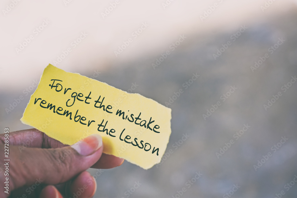 Wall mural inspirational quote on piece of paper - forget the mistake remember the lesson.