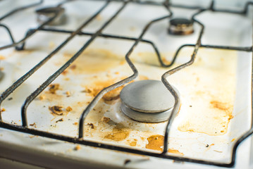 Dirty messy white gas stove close up