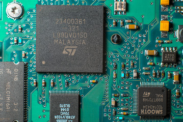 Minsk, Belarus, 2018. Computer chip on green motherboard closeup macro. Computer technology concept