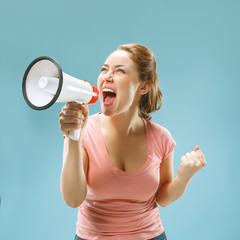 Woman making announcement with megaphone at blue studio