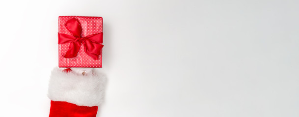 Santa holding a Christmas gift on a white background