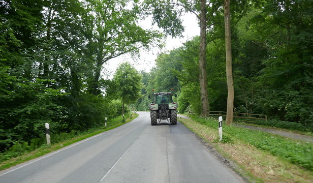 Tractor from behind, on a lonely country road