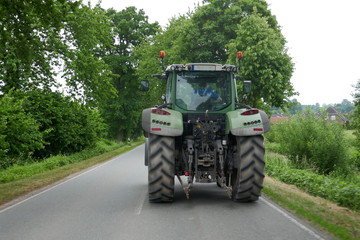 Tractor from behind, on a lonely country road