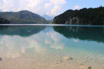 The sky and clouds are reflected in the lake