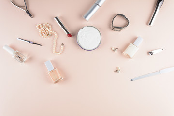 Skin care concept. Feminine accessories, nail polish, hand cream on puffy background. Flat lay. Top...