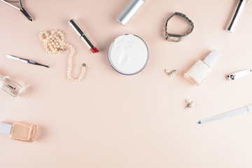 Skin care concept. Feminine accessories, nail polish, hand cream on puffy background. Flat lay. Top...