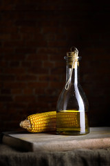 Corn oil in a glass transparent bottle. © YuryGulakov