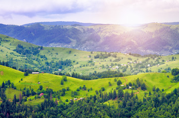 Naklejka na ściany i meble hills mountain slope of the Carpathians, beautiful scenery. houses of the village of Ukraine