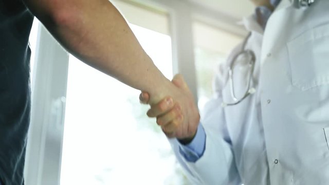 doctor and male patient handshake