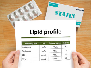 Physician checking blood laboratory results of lipid profile in high cholesterol patient and...