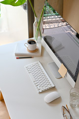 White workspace with modern desktop computer and office accessories