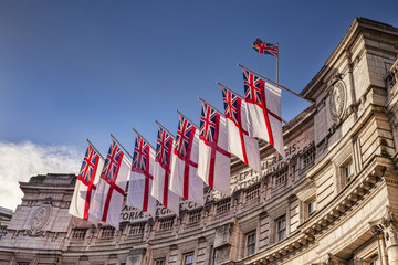 Admiralty Arch flying White Ensigns, the flag of the Royal Navy.