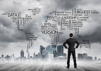 Motivation and inspiration concept with modern cityscape and businessman observing it