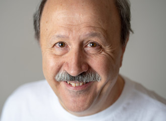 Close up portrait of smiling senior man with happy face looking at the camera