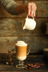 Latte - a cup of coffee with milk in a transparent cup on the table. top view.