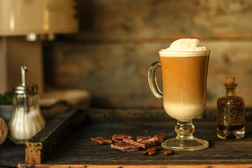 Latte - a cup of coffee with milk in a transparent cup on the table. top view.