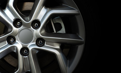 closeup alloy car wheels with soft-focus and over light in the background
