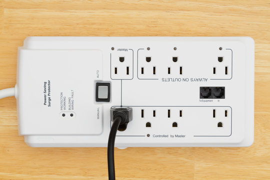 A power surge protector on wood