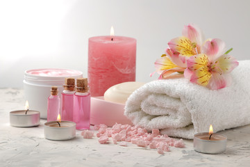Spa composition with sea salt, aroma oils, towels and soaps and body scrubs. spa concept. on a light background.