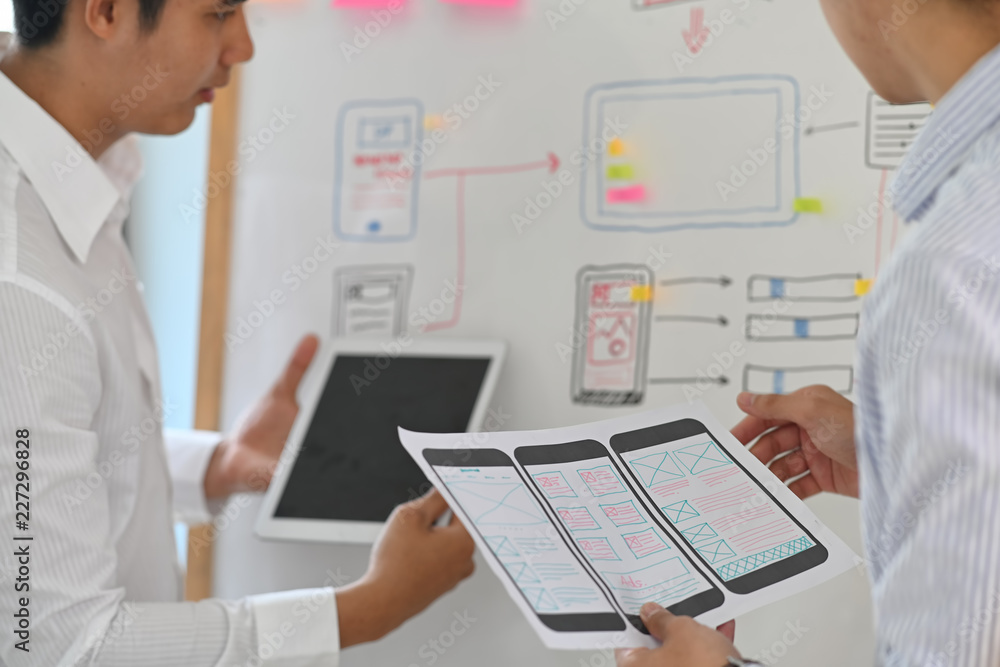 Poster web designer teamwork concept ux ui designer planning layout application for mobile phone mockup on 