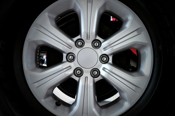 closeup alloy car wheels with soft-focus and over light in the background