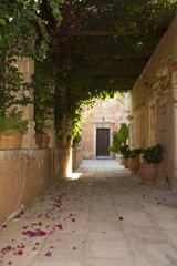 Fototapeta na wymiar Alley in monastery of Agia Triada, Crete, Greece. Monks cell entrance door