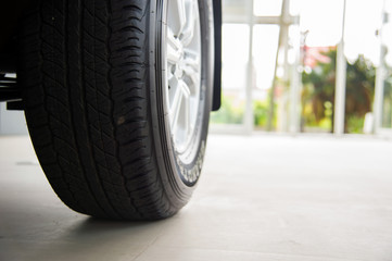 closeup car wheels with soft-focus and over light in the background