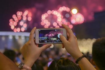 Holiday, colorful sky, fireworks shoots on smartphone