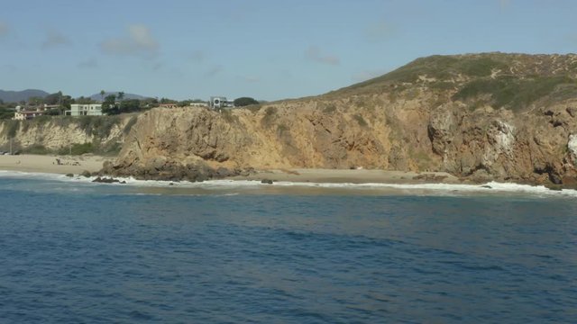 Aerial panning shot of a private beach