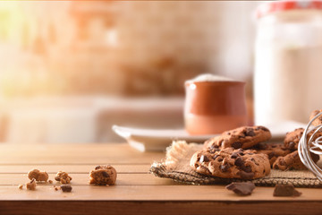 Homemade biscuits with chocolate chips on wooden slatted table front