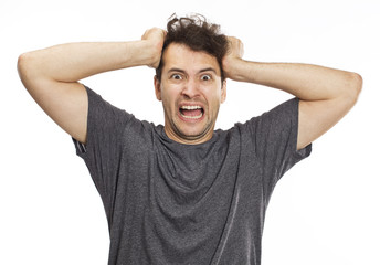 Portrait of an angry and furious male on a white background