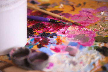 artists brushes and oil paints on wooden palette