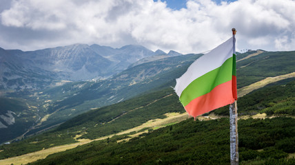 The Bulgarian flag waving with the view of Mount Musala