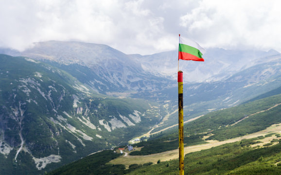 The Bulgarian flag waving with the view of Mount Musala