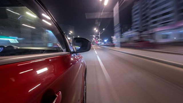 Drivelapse urban look from fast driving car at a night avenue in a city timelapse hyperlapse