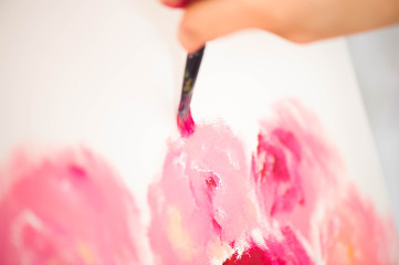 Artist close-up painting flowers.
