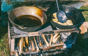 Caucasian haluz dish with meat and cheese is prepared in a frying pan with boiling oil