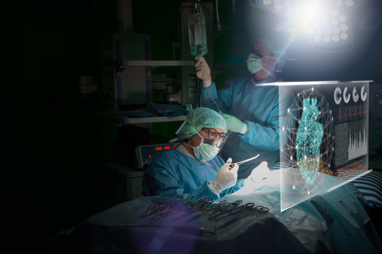 Doctor or Surgeon analyzing patient heart testing result and human anatomy on technological digital futuristic virtual interface,digital holographic, innovative in science and medicine concept.