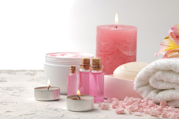 Spa composition with sea salt, aroma oils, towels and soaps and body scrubs. spa concept. on a light background.