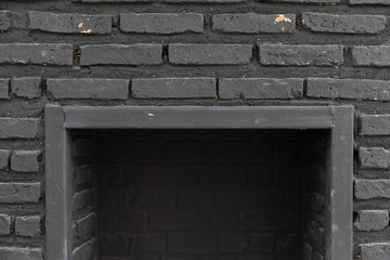 empty fireplace with black cement brick wall.