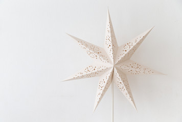 close up of vintage white  lantern with star shape on empty wall.
