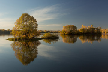 Soft autumn landscape, reflected in calm water