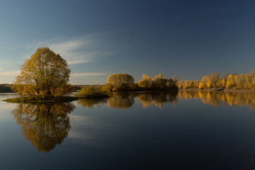 Fototapeta na wymiar Soft autumn landscape, reflected in calm water
