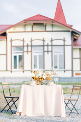 Stylish printing at the wedding ceremony, beautiful details and decor with flowers and rings. Wedding invitations made by hand with calligraphy