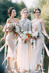 Beautiful bride in front of wedding arch with flowers and decor. Bouquet in the hands and details. The girl is happy, smiling and dancing. Dream wedding dress in modern style © pavelvozmischev