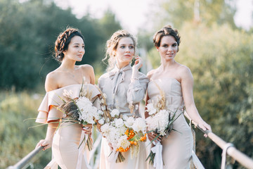 Beautiful bride in front of wedding arch with flowers and decor. Bouquet in the hands and details....